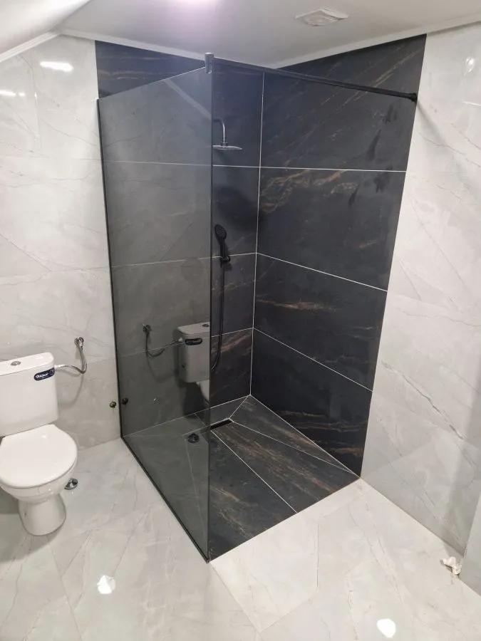 Walk-in tuš kabina po mjeri, fiksna staklena stjenka, parsol sivo kaljeno staklo i crni okov, izrada StakloDom